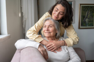 Senior woman and adult daughter hugging